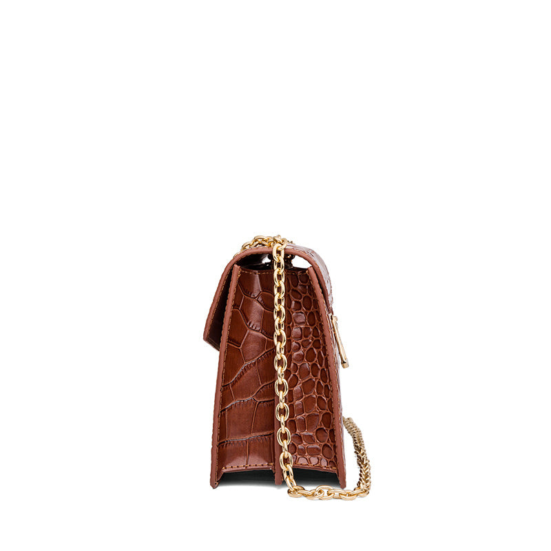 Brown crocodile-patterned handbag with a gold chain on a white background