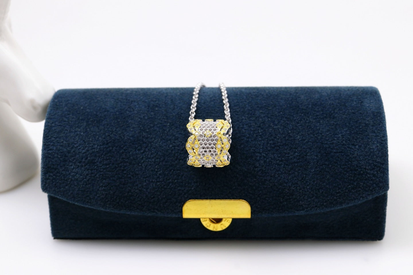 Navy blue handbag with gold accents on a white background