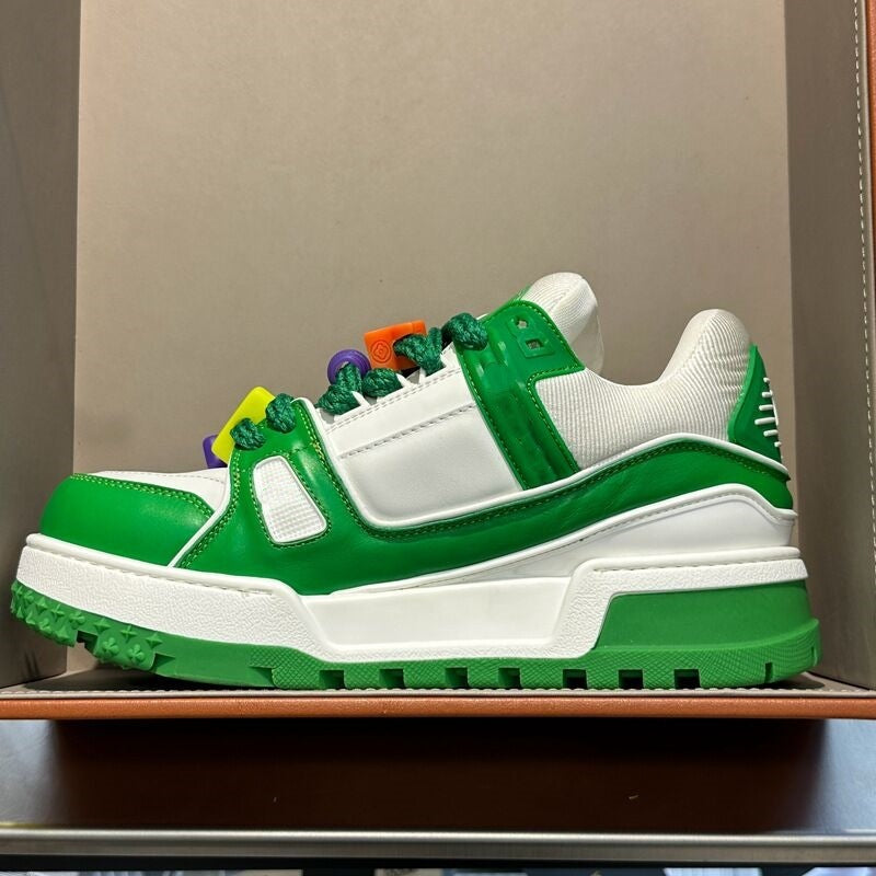 Green and white sneaker with colorful accents on a neutral background