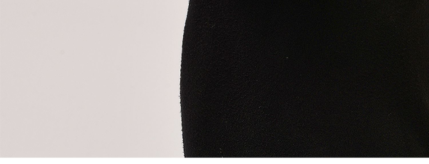 Close-up of a black fabric texture on a light gray background