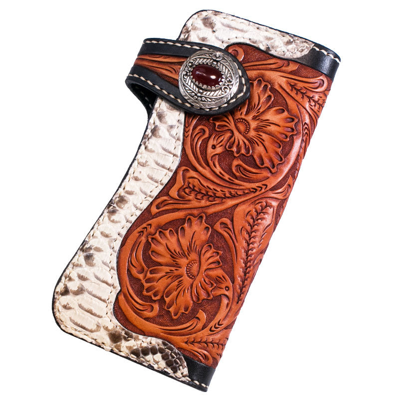 Handcrafted leather wallet with intricate designs and a decorative clasp on a white background