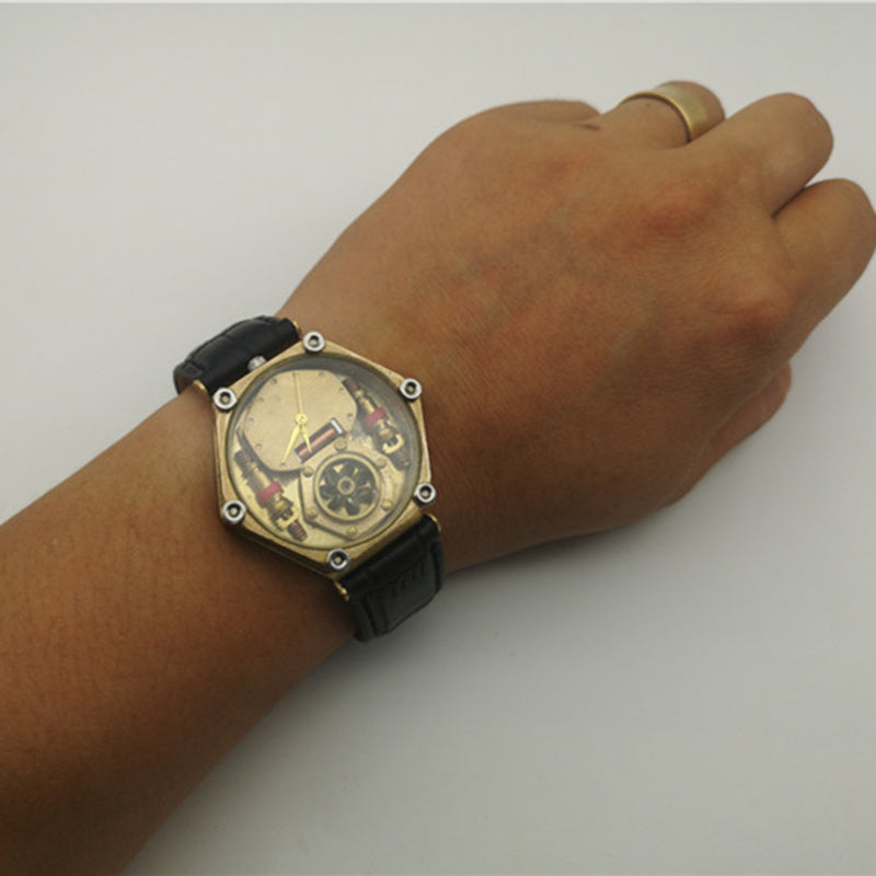 Hand wearing a detailed wristwatch with a black strap on a plain background