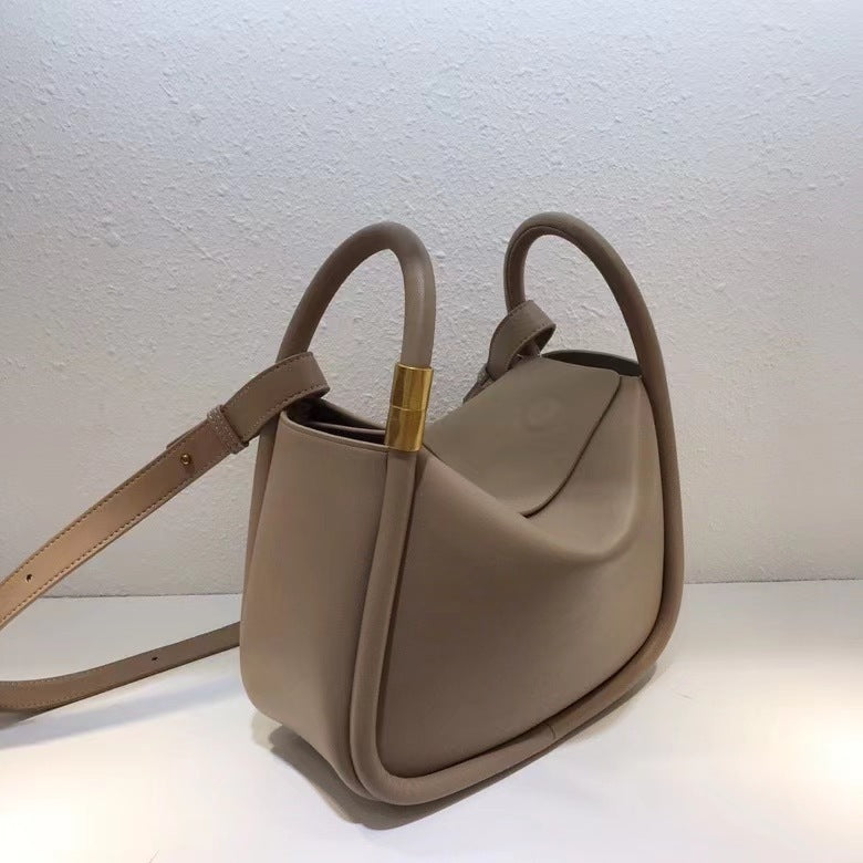 Beige handbag with a gold clasp on a white background