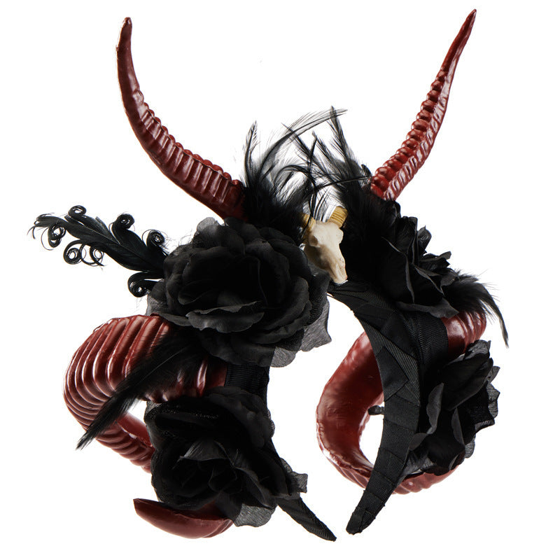 Pair of ornate headbands with red horns and black flowers on a white background