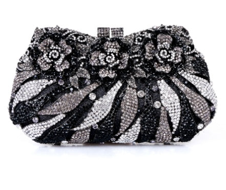 Black and silver beaded clutch bag on a white background