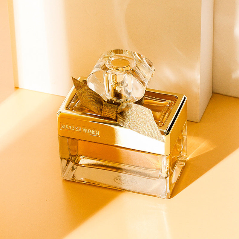 Gold and clear perfume bottle with 'Sheeress' branding on a beige background