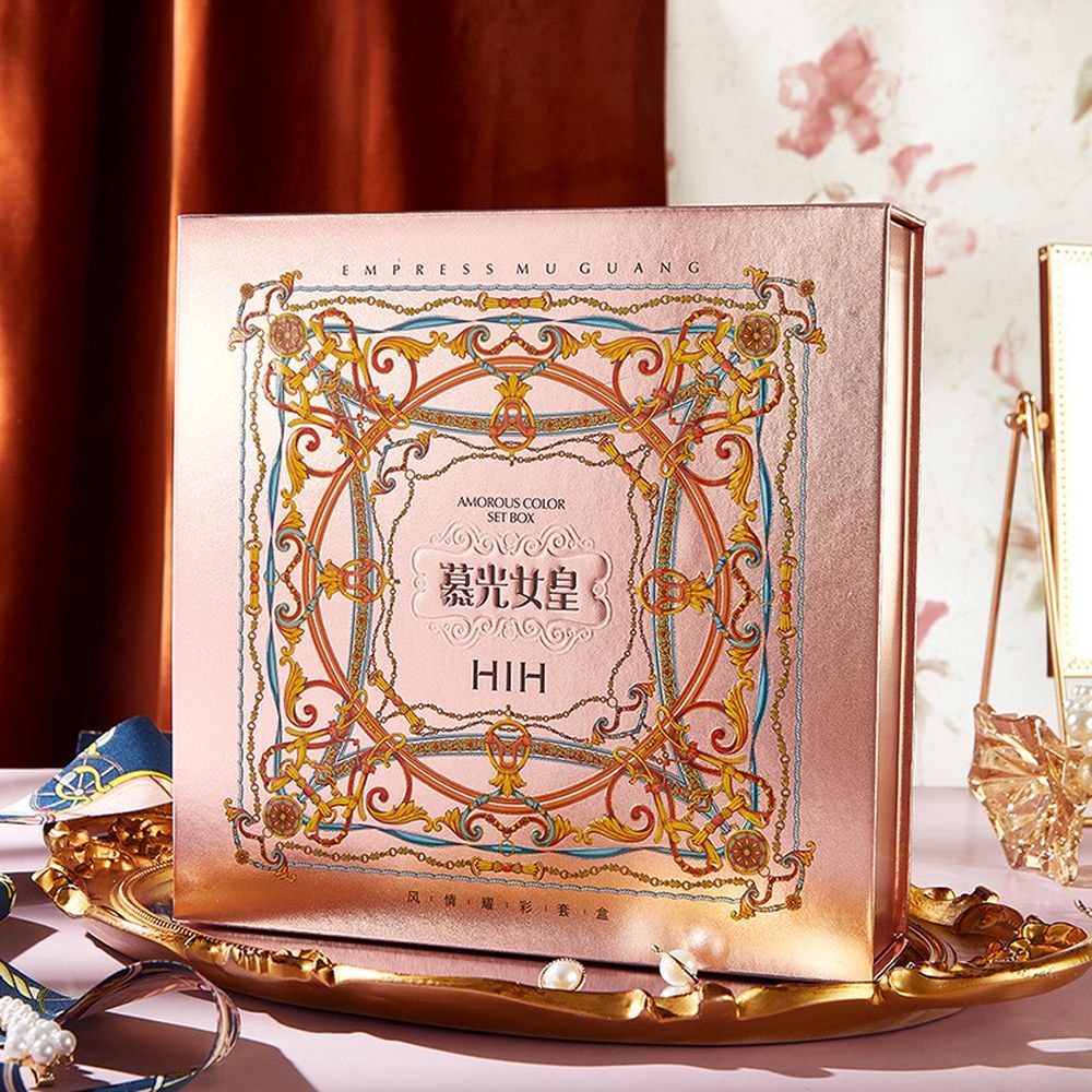Decorative box with intricate design and text on a table with decorative items.