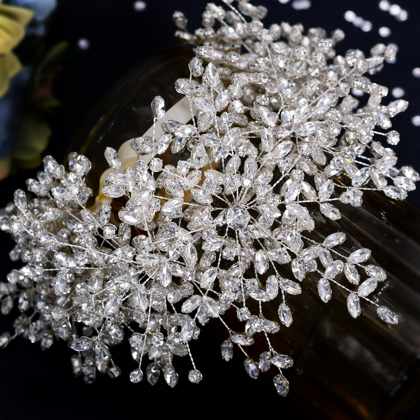 Close-up of a decorative hairpiece with sparkling crystals on a dark background
