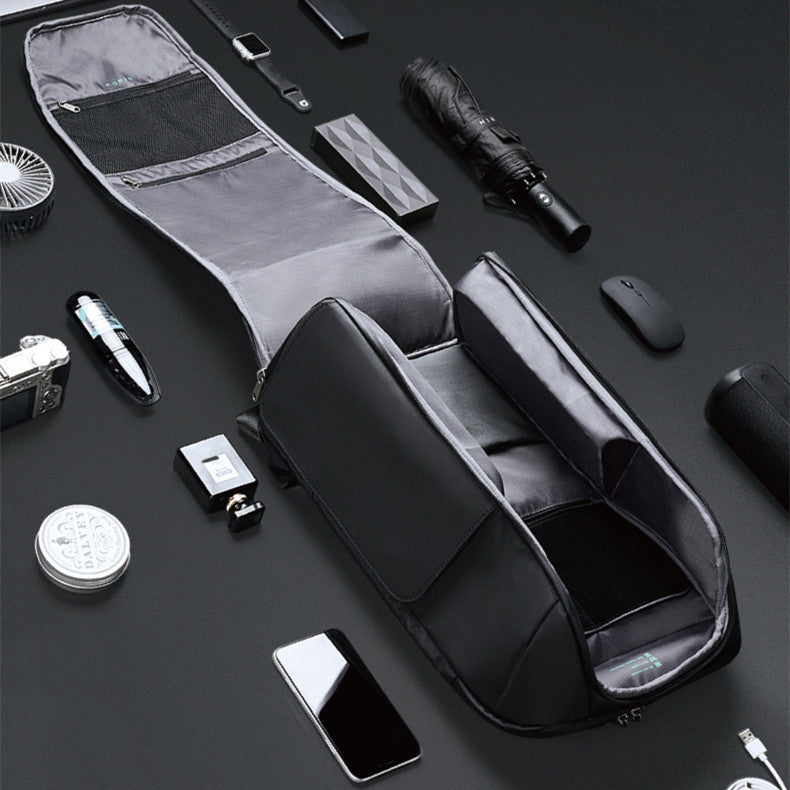 Black travel bag with various travel items on a dark surface