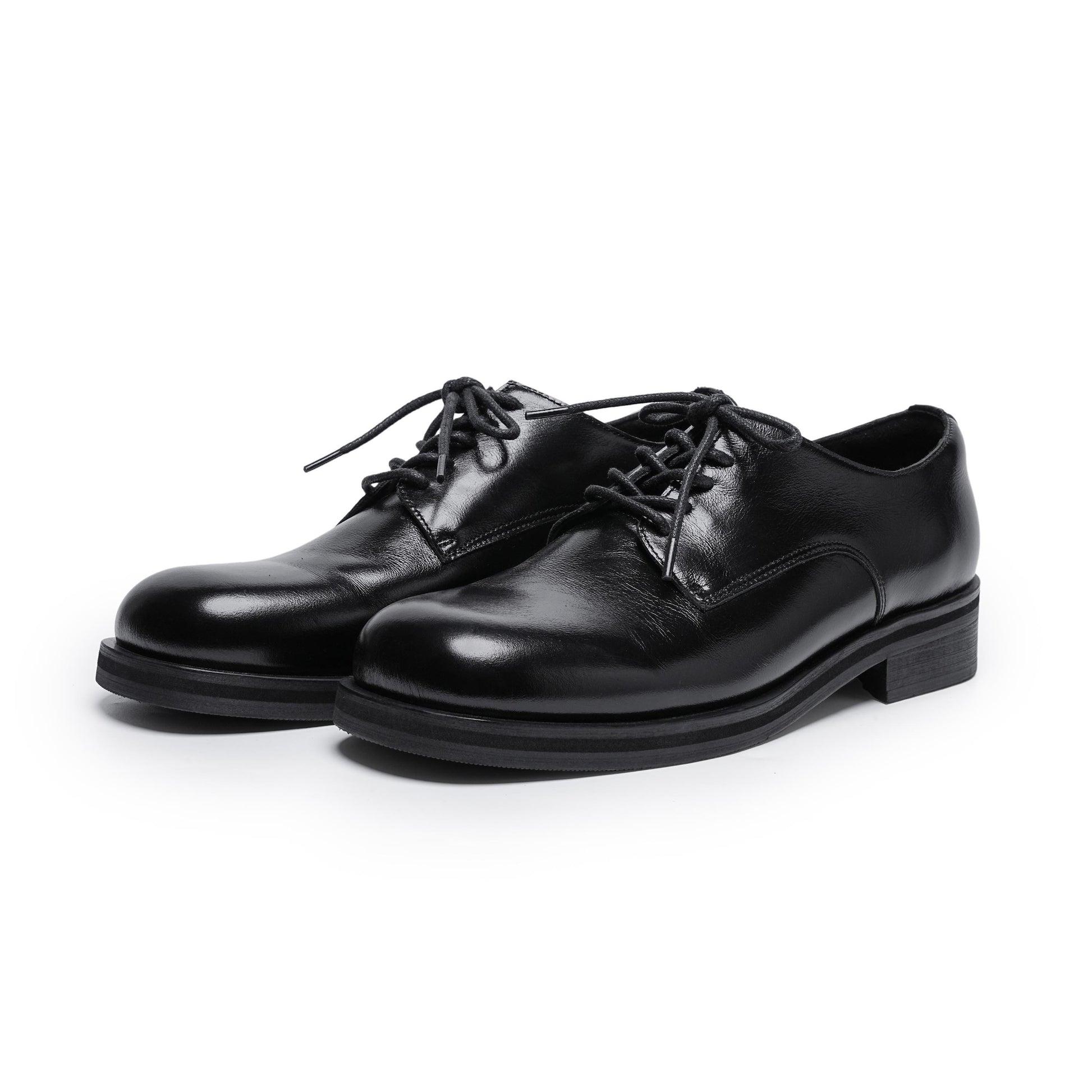 Pair of black leather dress shoes on a white background