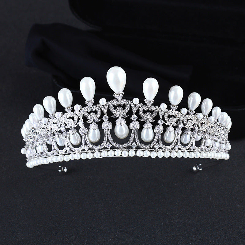 Silver tiara with pearls on a black background