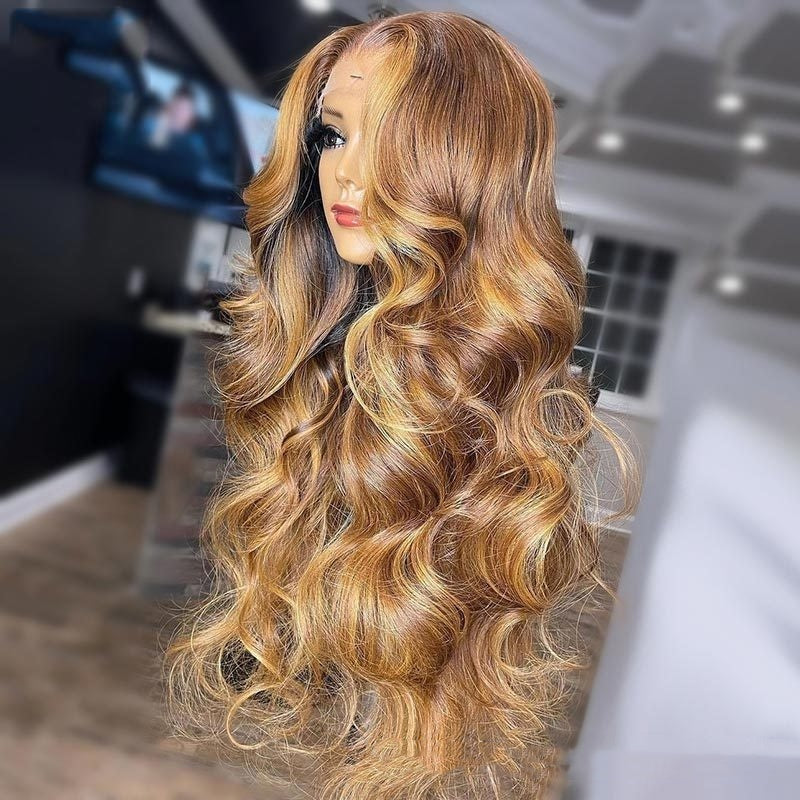 Blonde wavy wig displayed on a mannequin head with a blurred indoor background