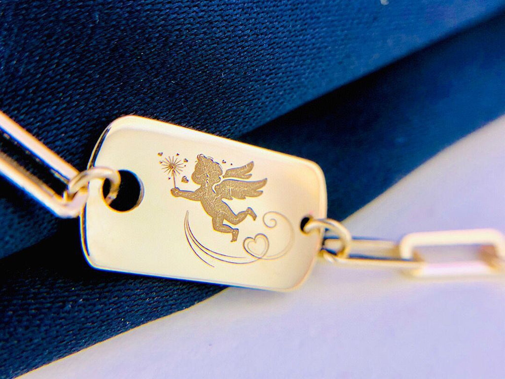Gold keychain with angel design on a blue and white background