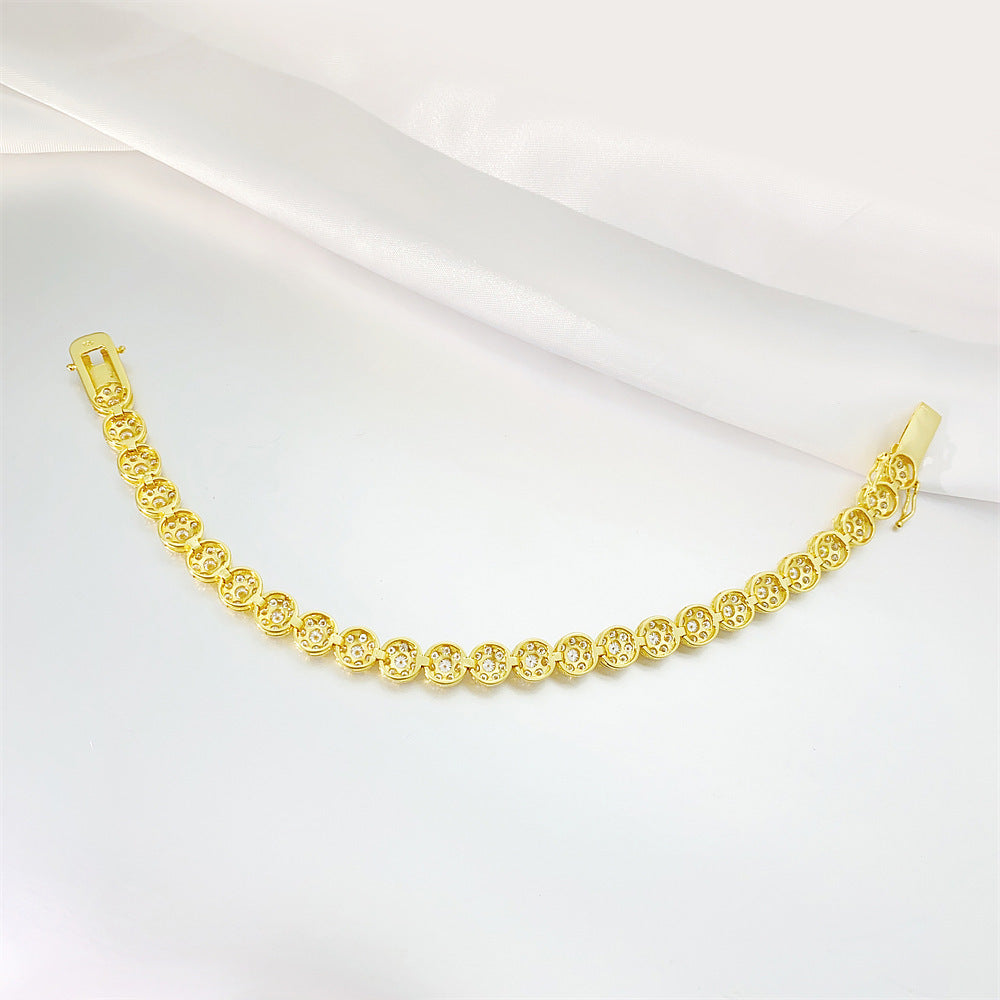 Gold bracelet on a white fabric background