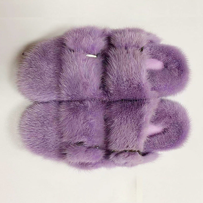 Purple fluffy slippers on a white background
