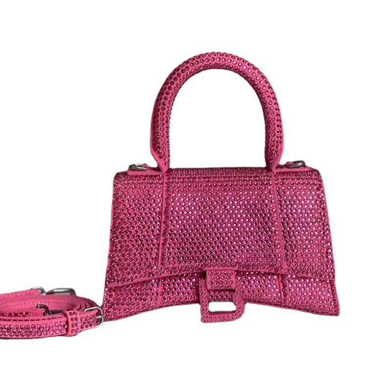 Pink handbag with a strap on a white background