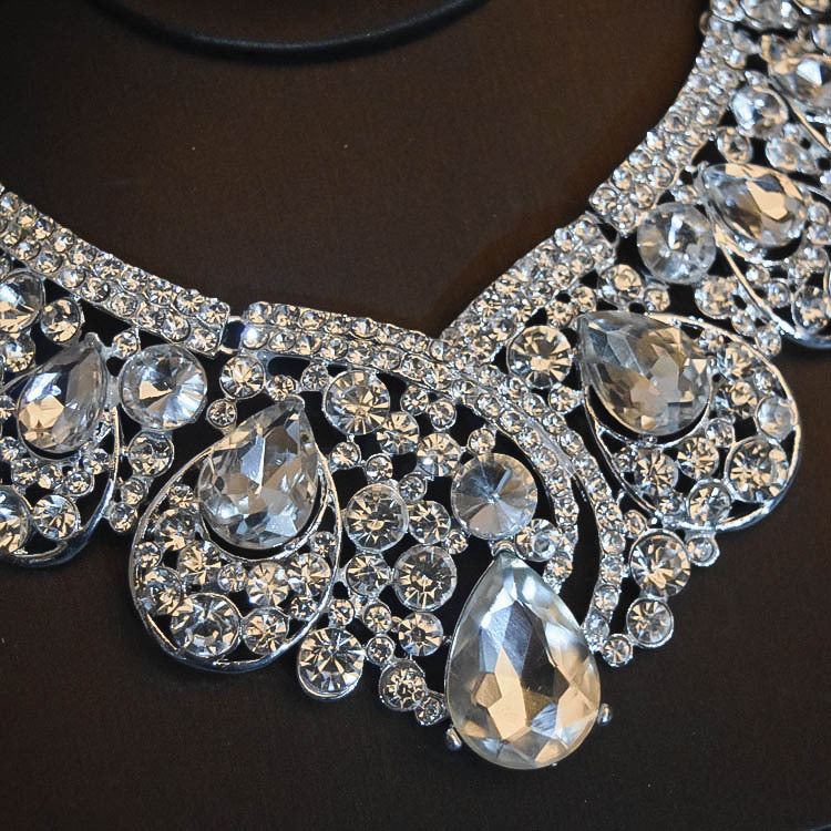 Close-up of a sparkling necklace with intricate design on a dark background
