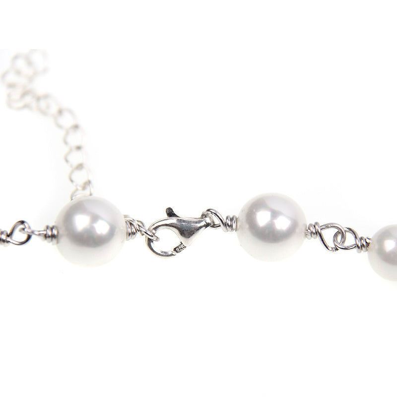 Pearl bracelet with silver clasp on a white background