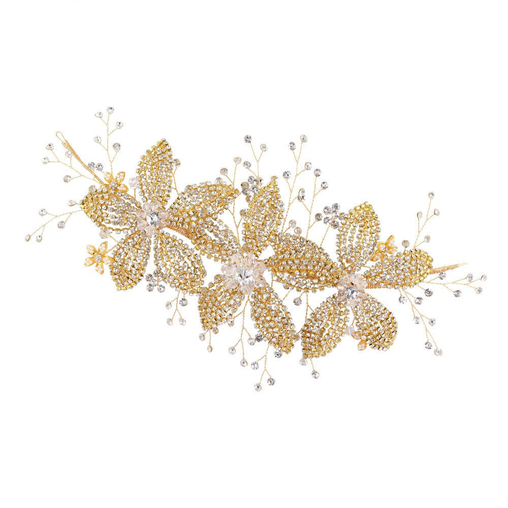 Gold butterfly hairpiece with beads on a white background