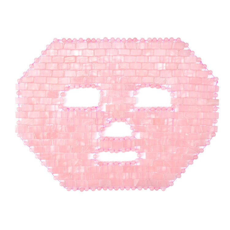 Pink face mask with a grid pattern on a white background