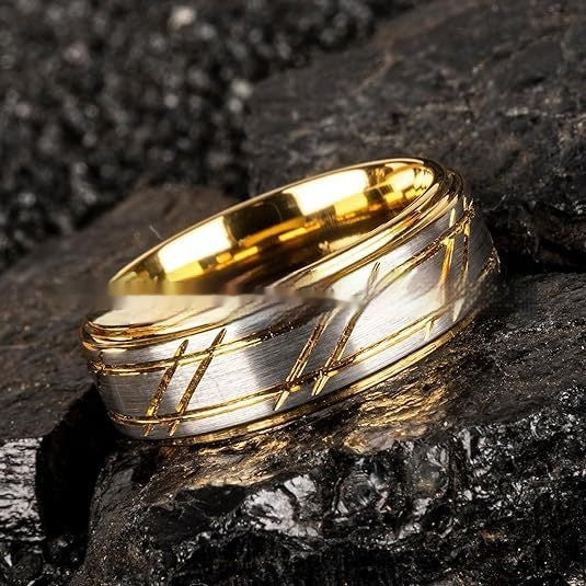 Gold and silver ring on a dark stone surface