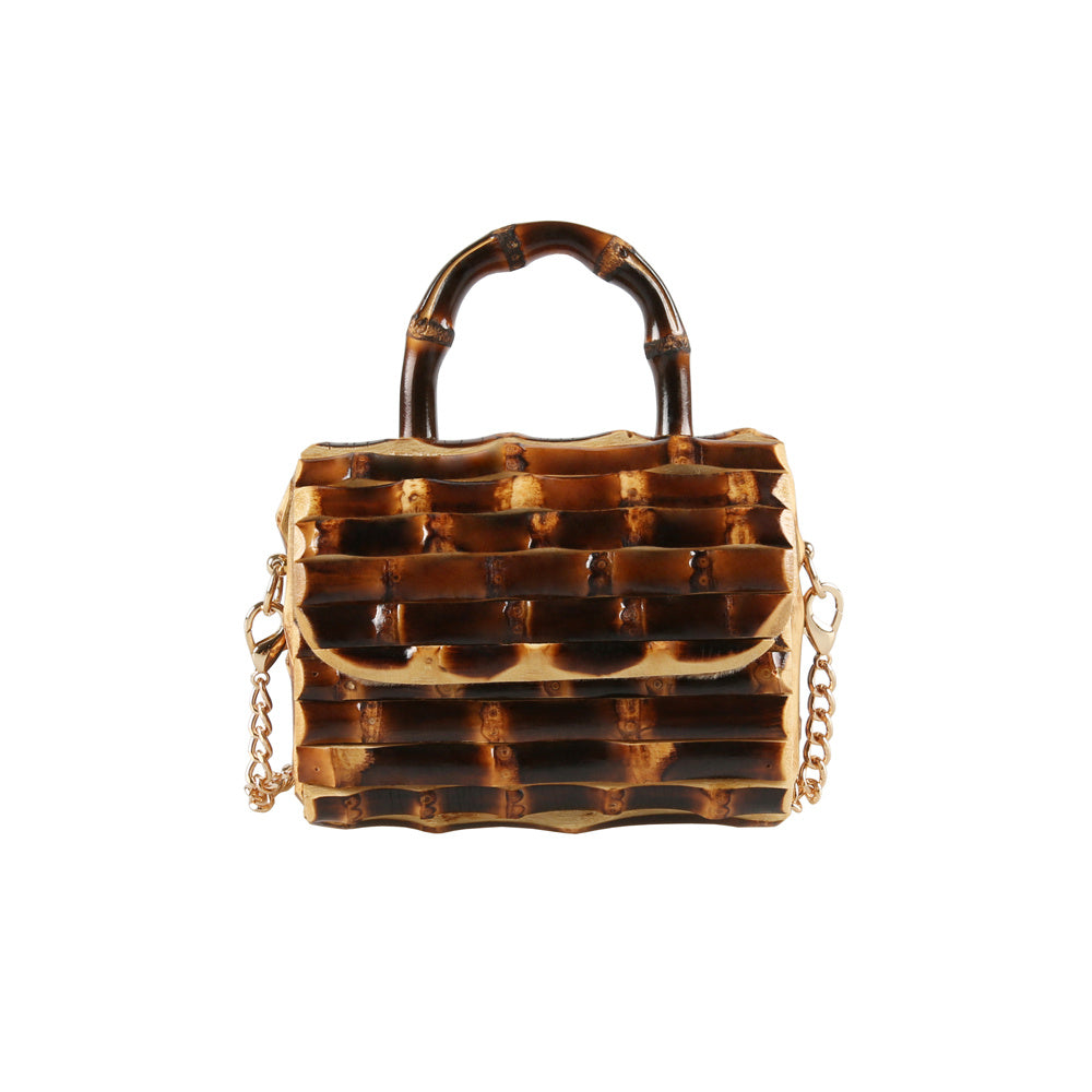 Tortoiseshell handbag with gold chain on a white background