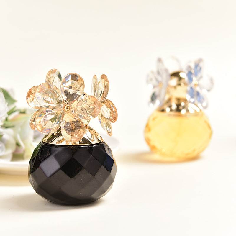 Decorative item with black base and gold floral design on a white background
