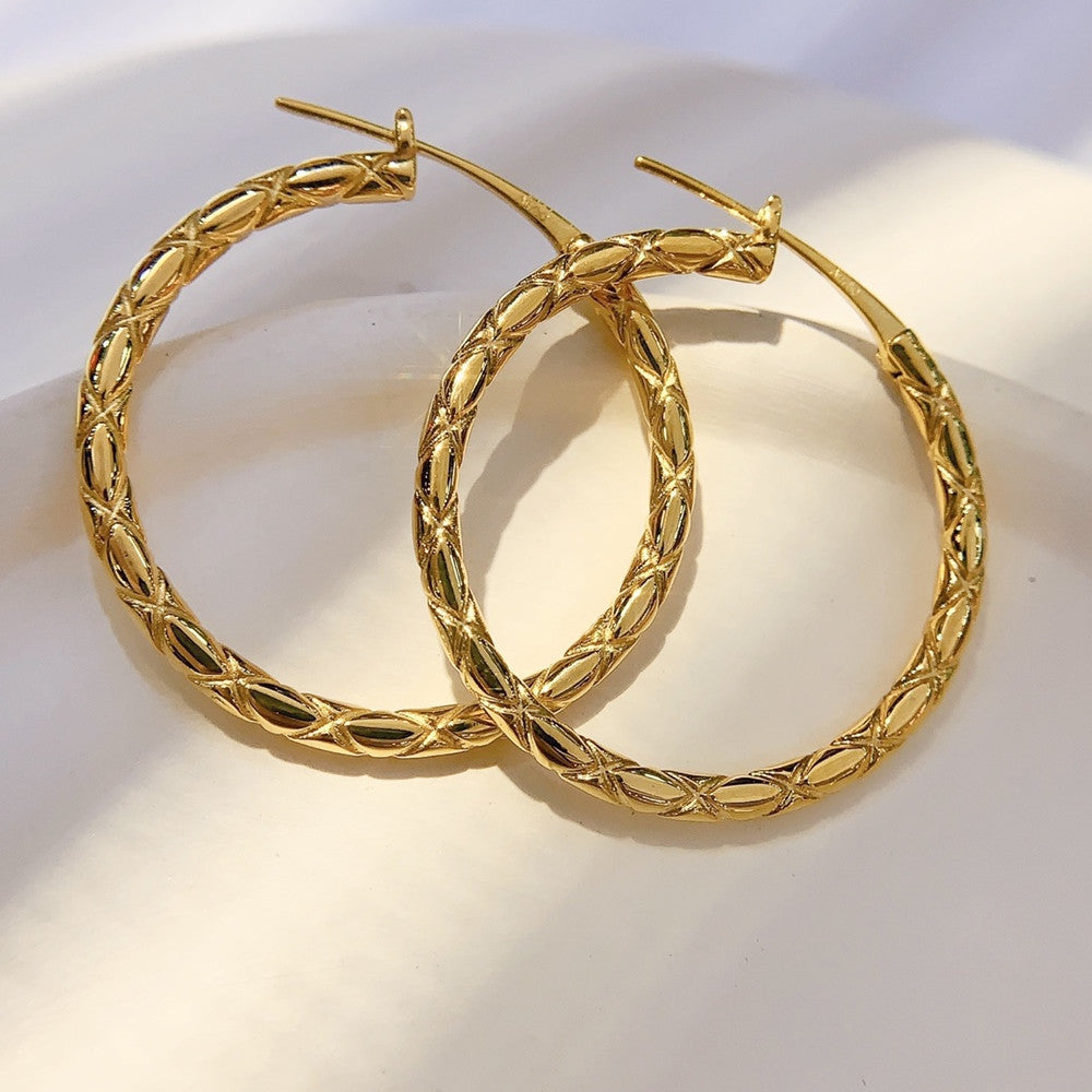 Gold hoop earrings on a white background