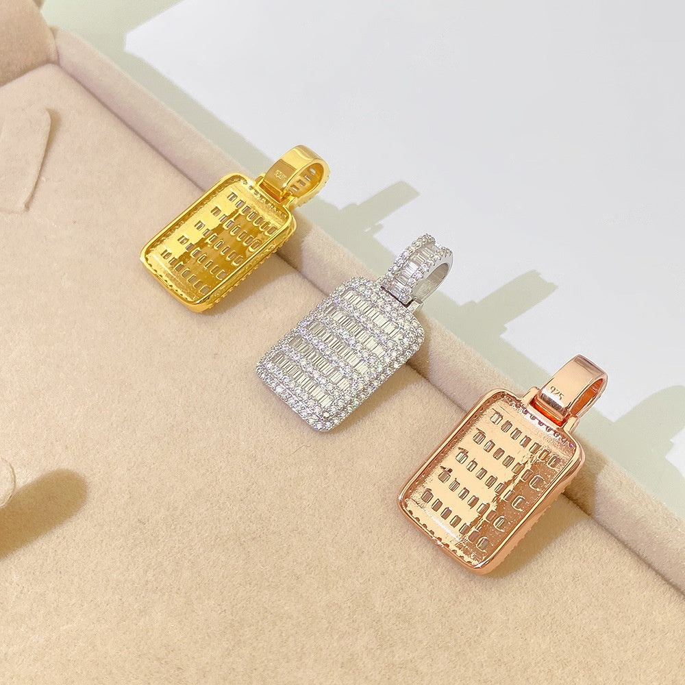 Three rectangular pendants in gold, silver, and rose gold on a beige surface.