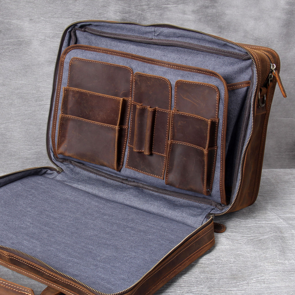 Open leather briefcase with gray interior on a gray background