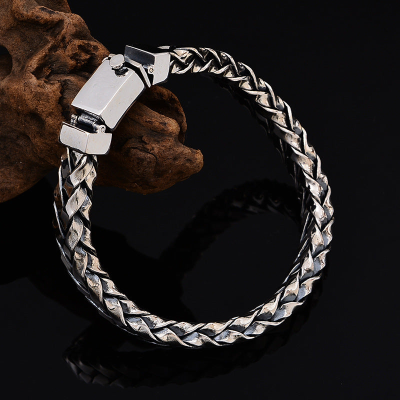 Silver braided bracelet on a dark background