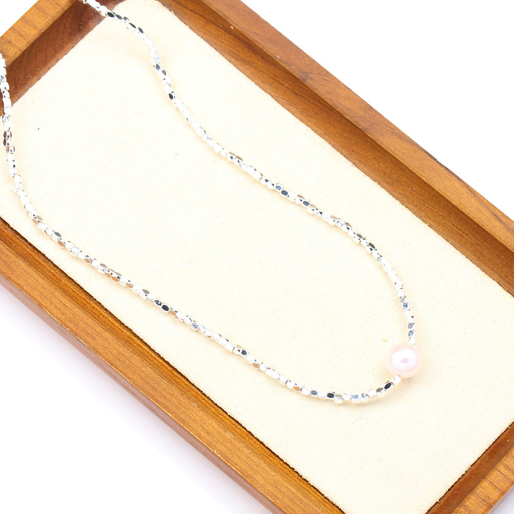 Necklace with a pearl pendant on a wooden display box