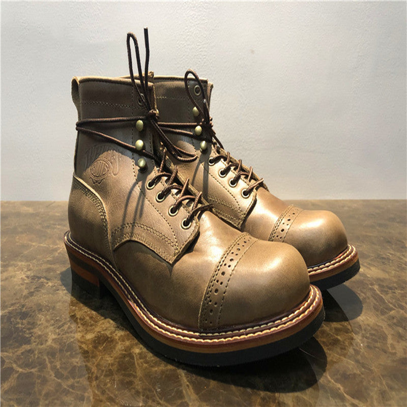 Pair of brown leather boots on a textured surface with a neutral background