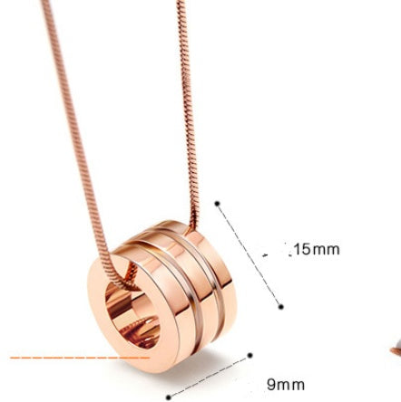 Rose gold necklace with a cylindrical pendant on a white background