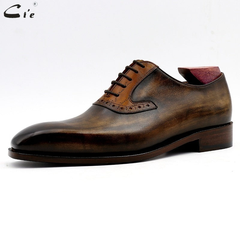 Brown leather dress shoe on a white background