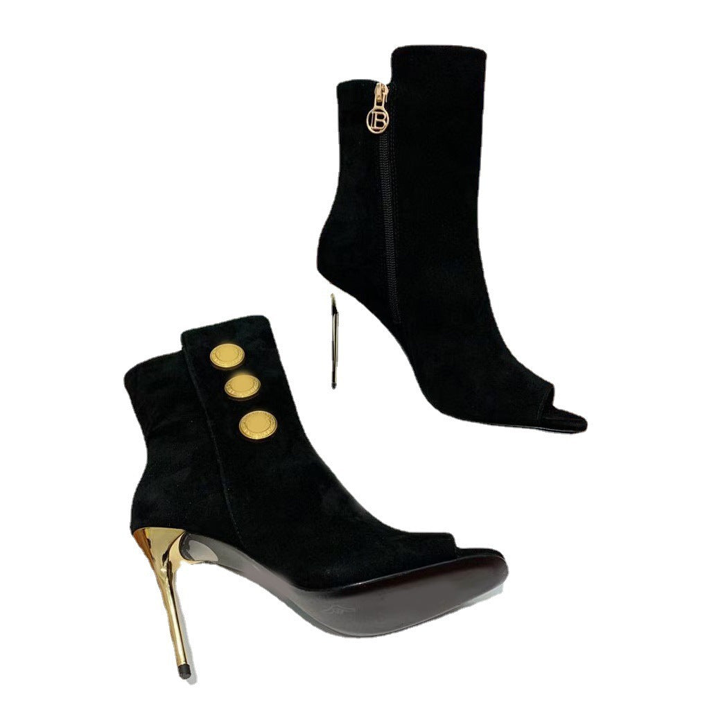 Black high-heeled ankle boots with gold accents on a white background