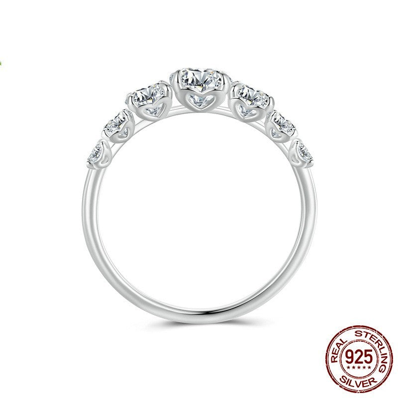Silver ring with gemstones on a white background, featuring 'Real Sterling Silver' stamp.