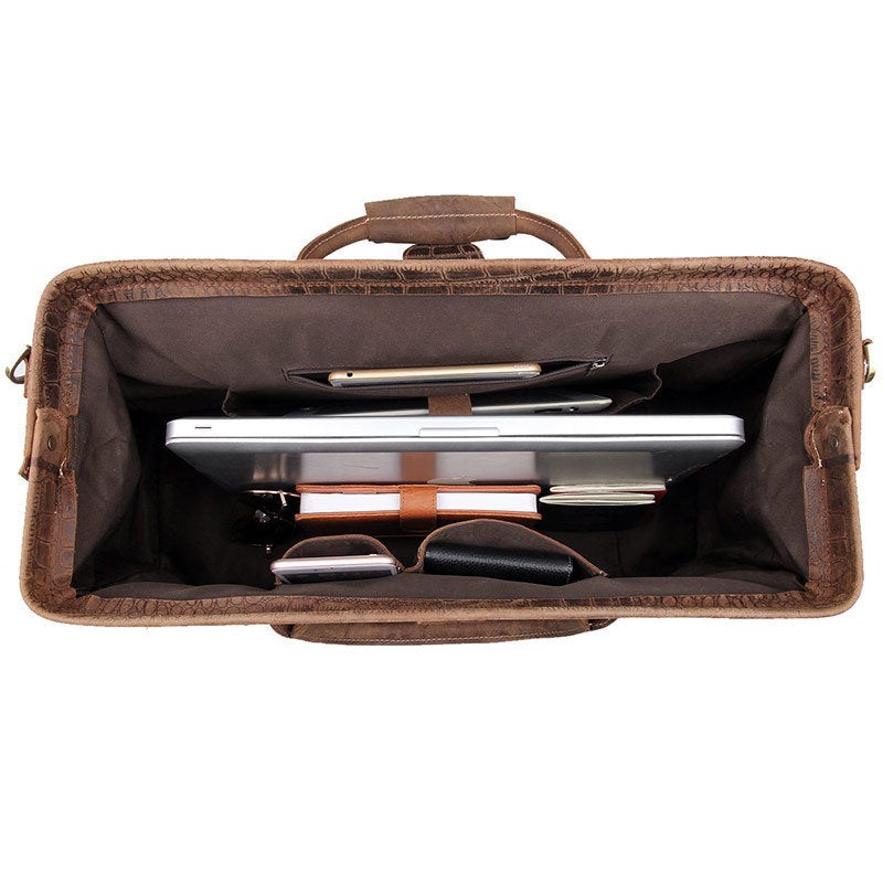Brown leather briefcase with interior compartments on a white background