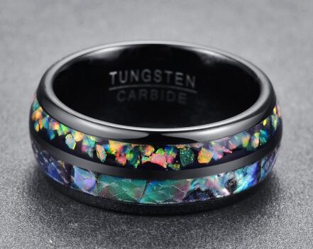 Black tungsten carbide ring with colorful inlay on a gray background