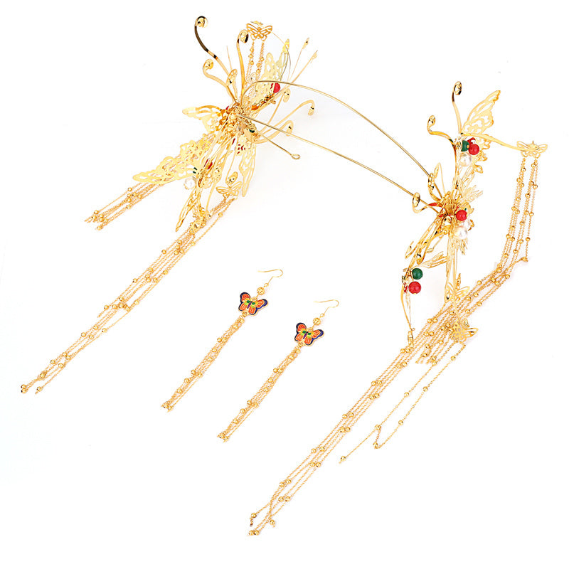 Gold hairpin and earrings set on a white background