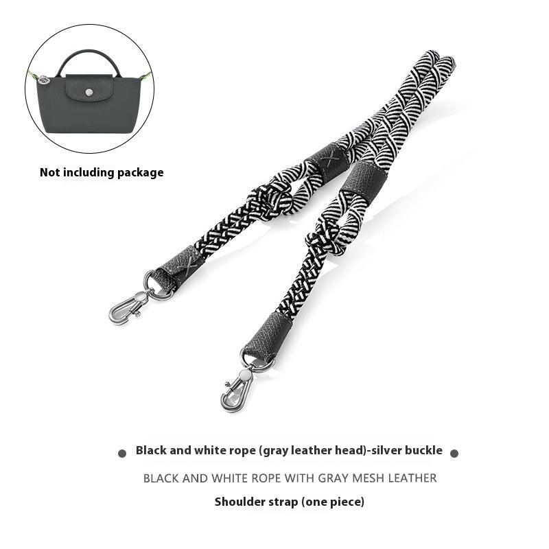 Black and white rope shoulder strap with gray leather head and silver buckle on a white background.