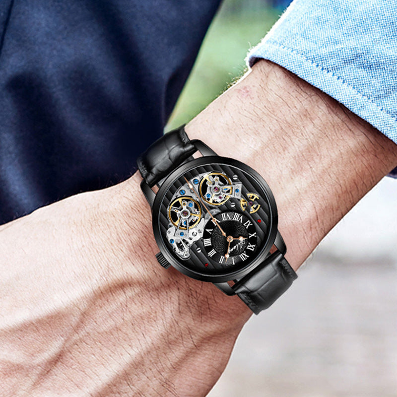 Close-up of a person's wrist wearing a black mechanical watch with a blurred background