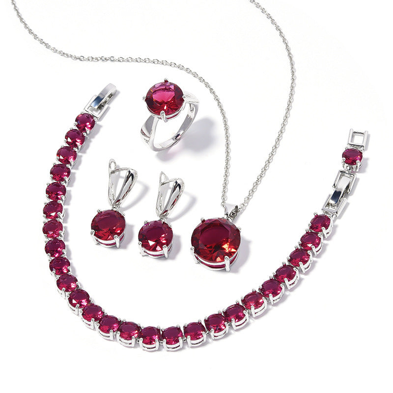 Jewelry set with red gemstones on a white background