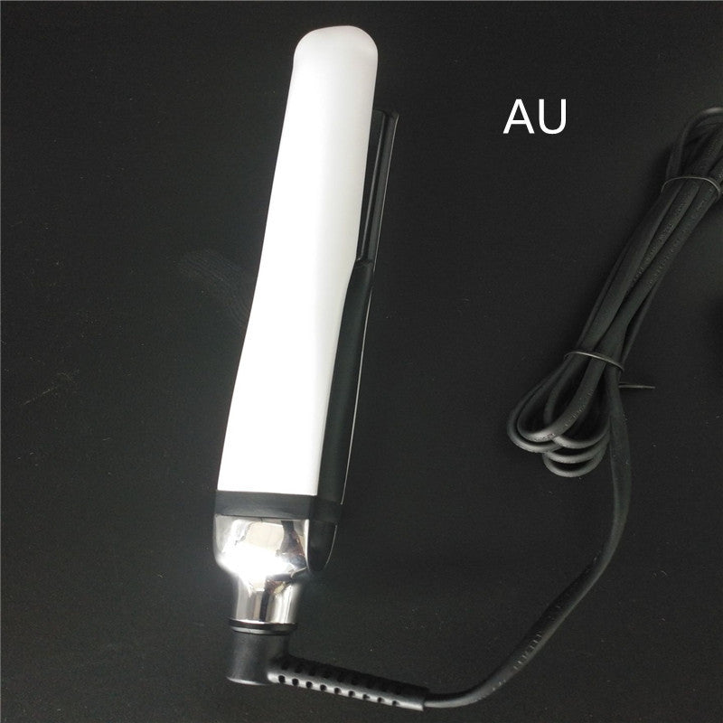 White electronic device with a cord on a black background, labeled 'AU'.
