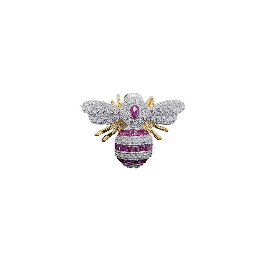 Diamond bee brooch with pink gemstone on a white background