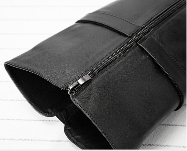 Black leather clutch bag with a zipper on a white background