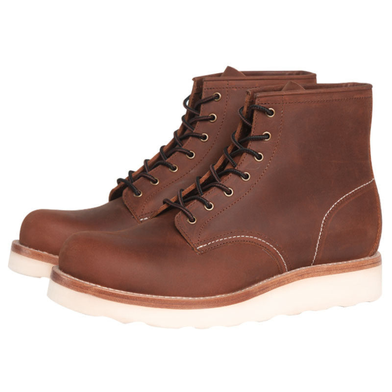 Brown leather boots with white soles on a white background
