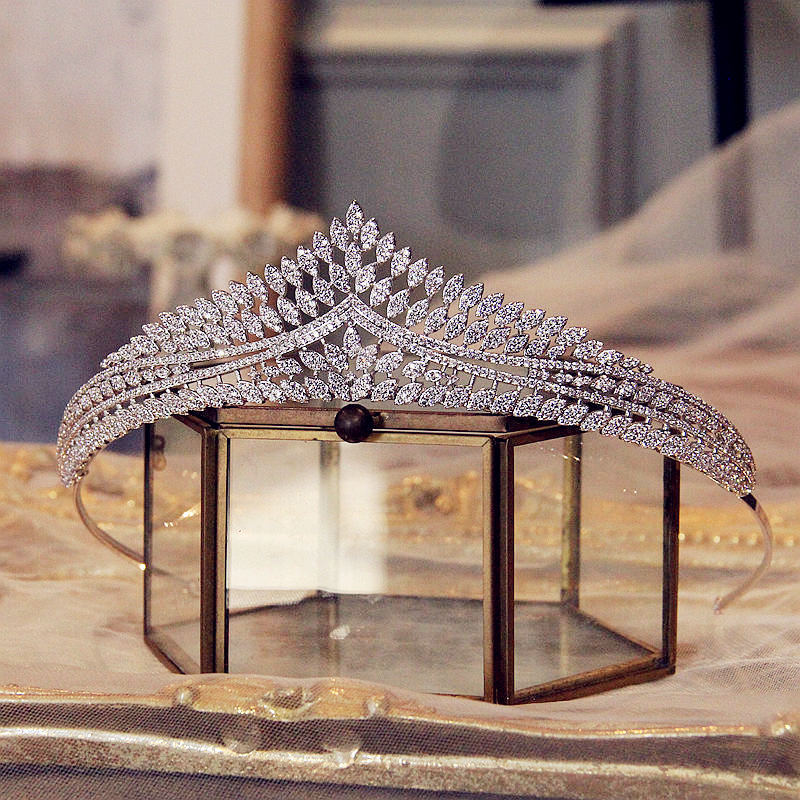 Silver tiara on a glass stand with a blurred background