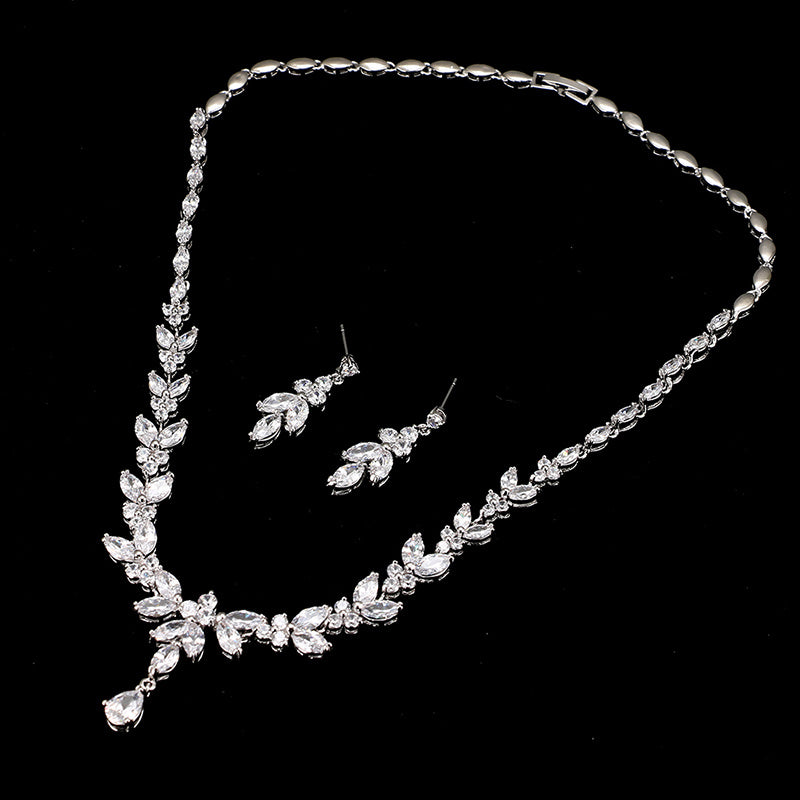 Silver jewelry set with necklace and earrings on a black background