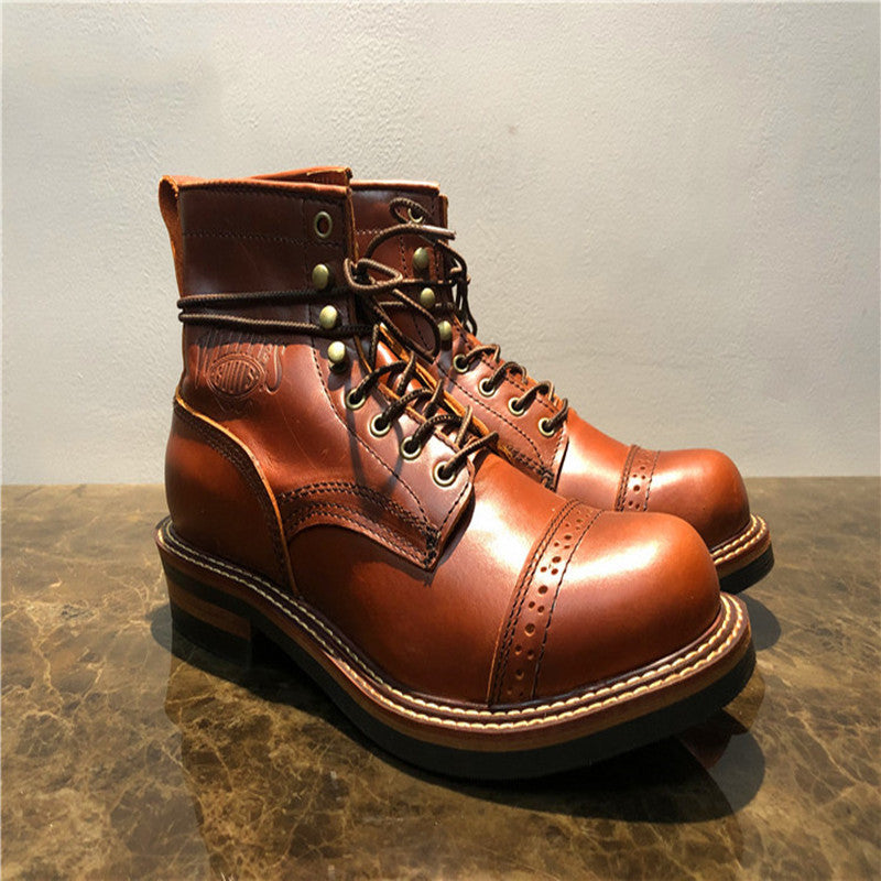 Brown leather boots on a reflective surface with a neutral background